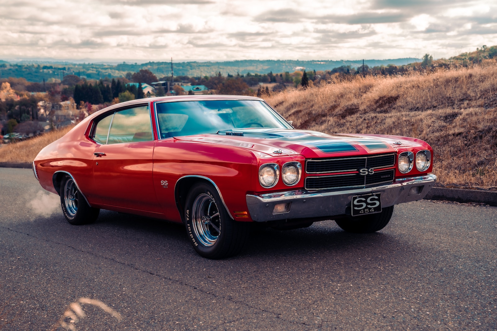 red chevrolet camaro on road during daytime